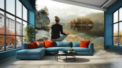 A young blond girl sit on peak and enjoy sun. Woman hiker watch sunrise. Impressive Autumn landscape The Eibsee Lake in front of the Zugspitze under sunlight. Amazing sunny day Wall mural