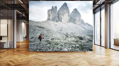 Man hiker with backpack on the Tre Cime di Lavaredo tour. beautiful surroundings at summer time, Dolomites in Italy, Europe Wall mural