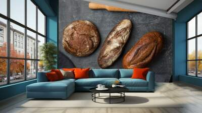 Rustic bread on dark background. Flat lay. Wall mural