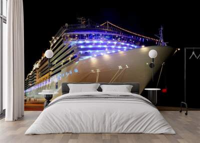 big modern cruise liner with lamps standing in dock at night Wall mural