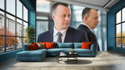 businessman in suit and tie stands near a mirror Wall mural