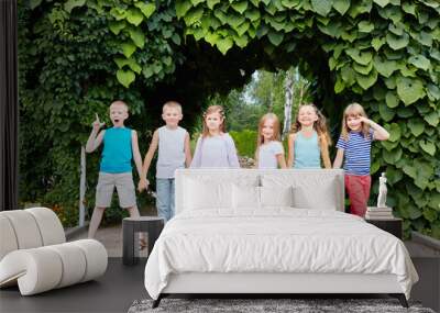 Children stand holding hands with their backs to tunnel Wall mural