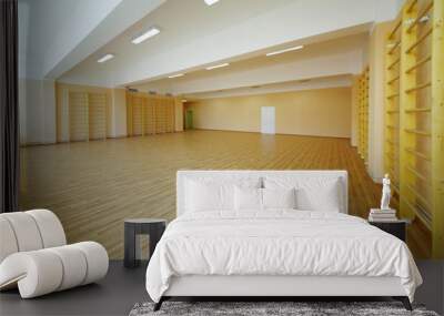 Empty school gymnasium floor with yellow and climbing near walls Wall mural