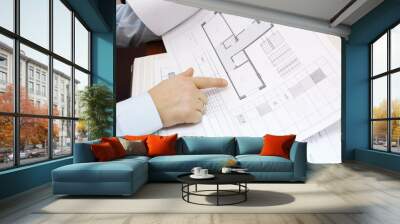 Hands of man looking drawings of apartment Wall mural