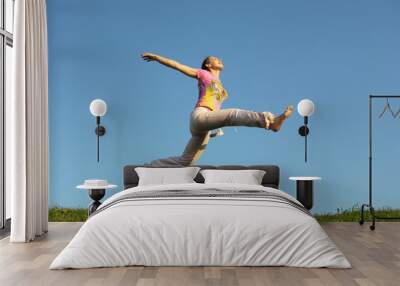 jump girl under sky Wall mural