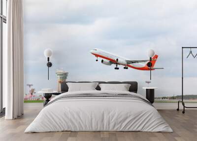 large red and white passenger airplane takes off at airport. Wall mural