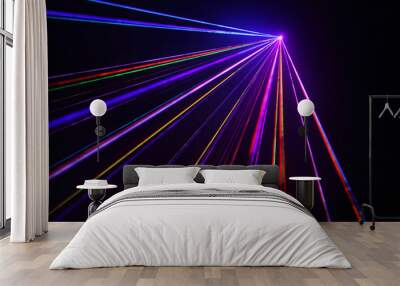 lot of beautiful multi-colored laser beams in dark at disco. Wall mural