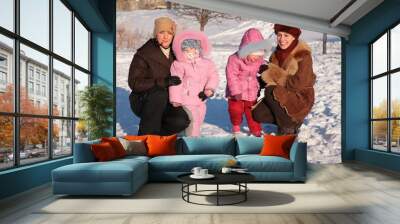 two mothers with children outdoor in winter Wall mural