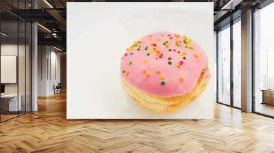 Pink round donut on white plate on white background Wall mural