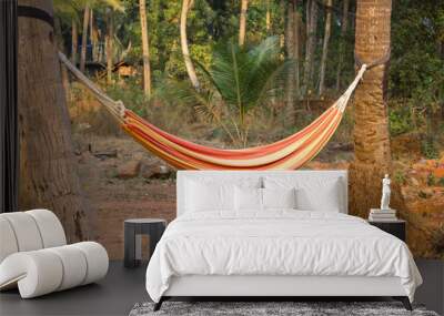 red-yellow hammock between two palm trees on a blurred background of the jungle Wall mural