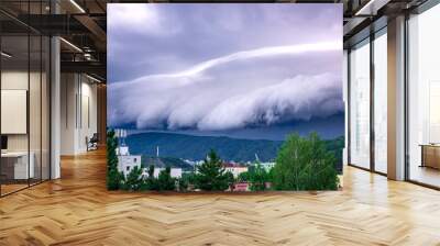 A massive Shelf cloud, Arcus cloud, is slowly rolling over the hill above the city Usti nad Labem Wall mural