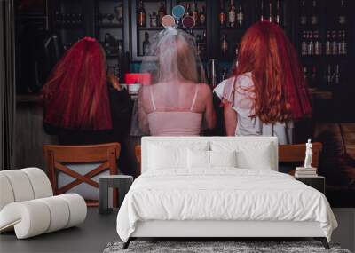 Back view of Three girls sitting in a bar Wall mural