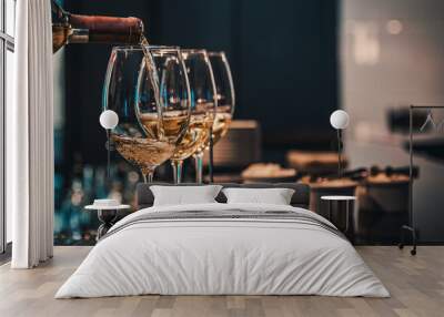 bartender pouring white wine into a glass in cafe or bar Wall mural