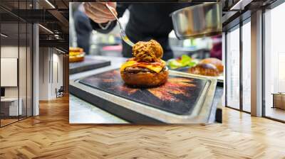 chef hand cooking cheeseburger on restaurant kitchen Wall mural