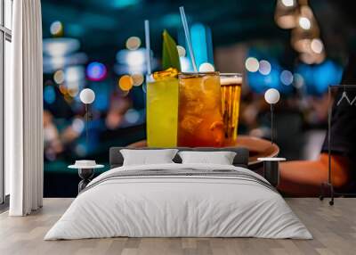 glasses alcohol cocktail set and beer on a waiter tray in bar Wall mural