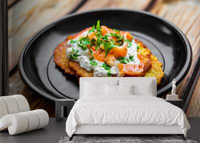 potato pancakes withsalmon fish and sour cream in a plate on wooden table Wall mural