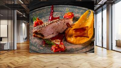 Roasted Duck breast fillets with pumpkin pure in plate on black wooden table background Wall mural