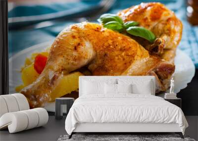 roasted half chicken with carrots, onions and potatoes served on a white plate on table Wall mural