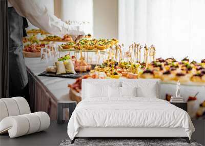 waiter prepare food for a buffet table in a restaurant Wall mural