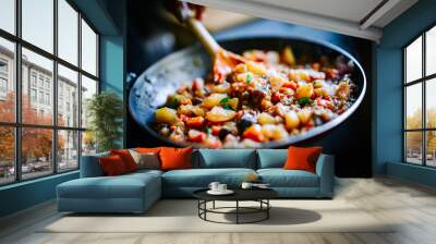 Woman cooking tasty vegetable stew in pan on kitchen Wall mural