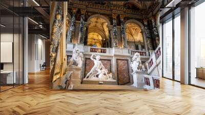 Vienna, Austria - July 6 2022: Museum of Art History, Kunsthistorisches Museum, Wien. Inside of the entrance in the art museum. Grand stairs up, with red marble, black pillars and white statues Wall mural