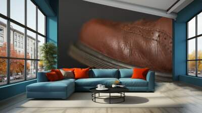 Vintage brown boots on black background, detail of retro shoes Wall mural