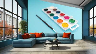 watercolor paints in box on blue background Wall mural