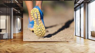 Athlete running sport feet on trail, selective focus on sole.Training workout on off road trail track design in advertising poster style Wall mural