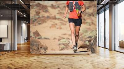 Female athlete run mountain race with hydratation trail vest for running Wall mural