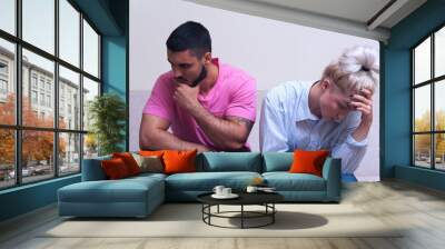 Unhappy couple sitting back to back Wall mural