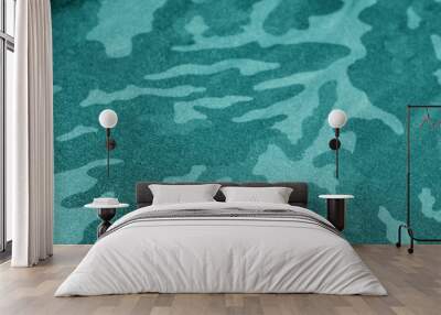 Old camouflage cloth with blur effect in cyan tone. Wall mural