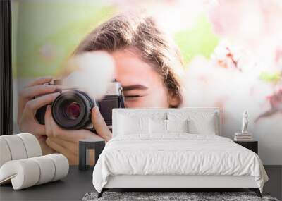 Young woman looks into camera lens and laughs Wall mural