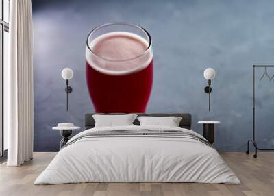 glass of red beer ale on a concrete gray table and copy space Wall mural