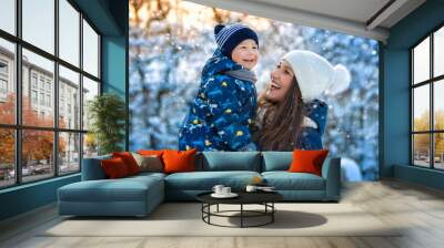 Woman and child in winter in nature. Portrait of a happy family Wall mural