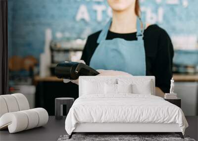  Precautions during quarantine. A gloved waiter with a cashless payment terminal. Wall mural