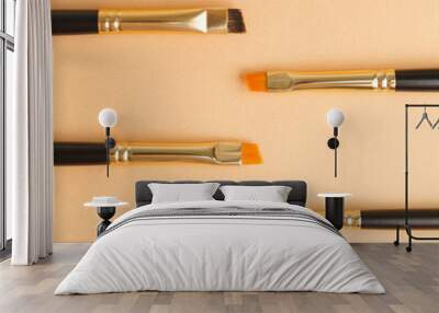 Set of gold and black brow brushes concept. Makeup artist's brushes on an isolated background. Wall mural