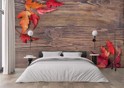 frame with autumn leaves on wooden background, top view Wall mural