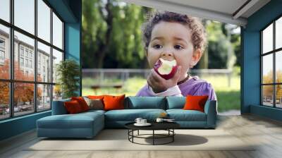 child eating apple Wall mural