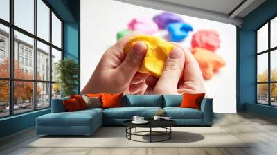 The hand of a girl who sculpts from light airy multi-colored plasticine. Wall mural