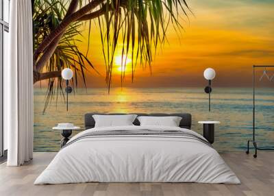 Beautiful landscape with sunset at tropical beach with palm trees Wall mural