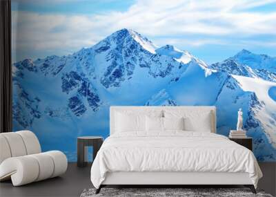 Mountains in snow. Panorama of winter landscape with peaks and blue sky Wall mural