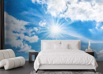 Sun with sunrays shining on blue sky Wall mural