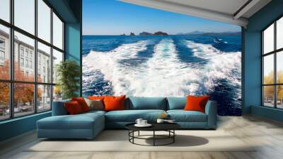 Waves on blue sea behind the boat Wall mural