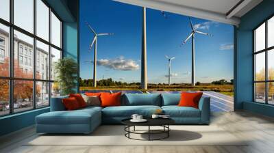 Wind turbines and solar panels closeup on sky background Wall mural