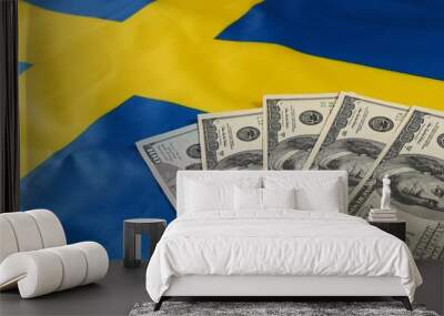 Currency exchange on a Swedish flag with banknotes displayed Wall mural