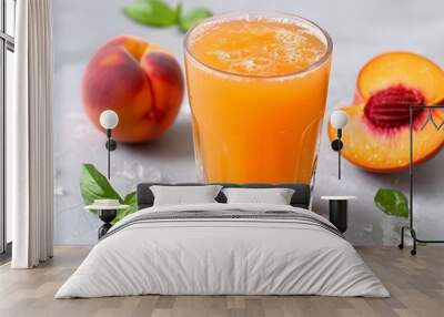 Refreshing peach juice served in a glass with fresh peach slices and mint leaves on a light background Wall mural