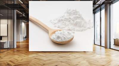 Close-up of tapioca starch or flour powder in wooden spoon on white background Wall mural