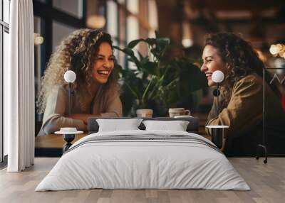 Two women sitting at a cafe and smiling. Young female friends meeting sit at table in coffee shop, generative ai Wall mural