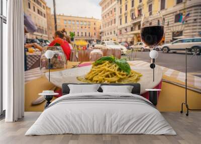 Glass of red wine served with pasta in Rome,Italy Wall mural