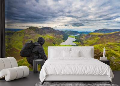 Hiker looks over Buttermere lake in English Lake District Wall mural